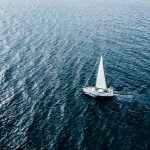 Aerial view of Sailing ship yachts with white sails  in deep blue sea