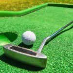 Golf ball and Golf Club on Artificial Grass